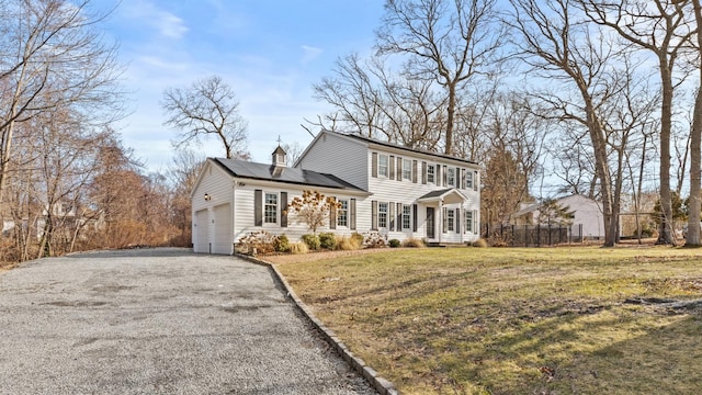 view of front of property with a garage, a front lawn, and solar panels