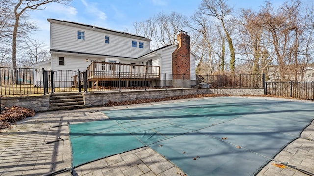 view of pool with a wooden deck and a patio area