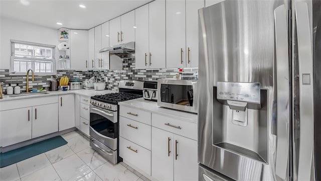 kitchen with white cabinetry, sink, backsplash, and stainless steel appliances