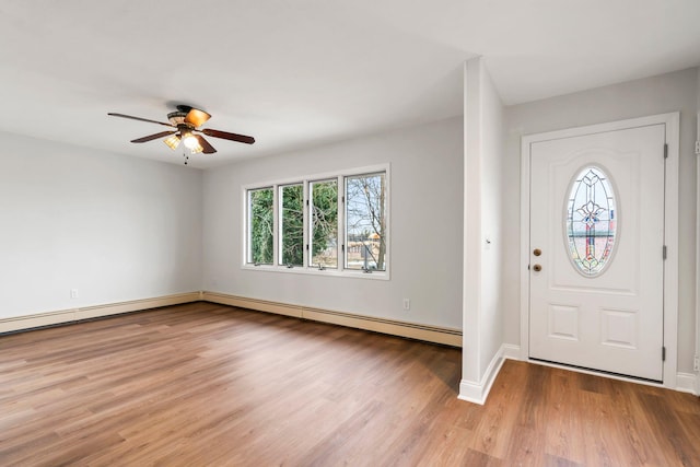 entryway featuring ceiling fan, baseboard heating, and light hardwood / wood-style flooring