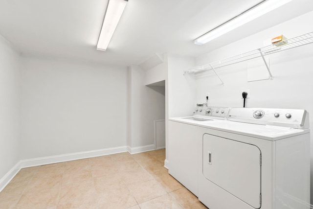 laundry area featuring independent washer and dryer and light tile patterned floors