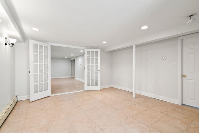 basement featuring light tile patterned flooring, french doors, and baseboard heating