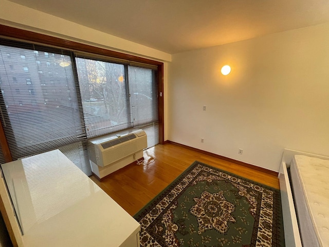 living room featuring hardwood / wood-style flooring and a wall unit AC