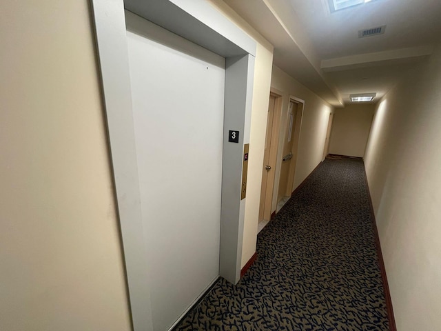 corridor featuring carpet floors and elevator