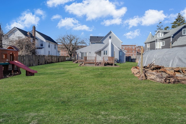 view of yard featuring a playground and a deck