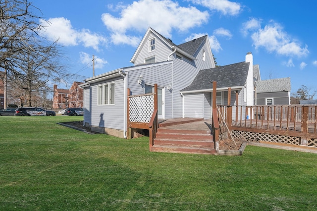 back of property featuring a wooden deck and a lawn