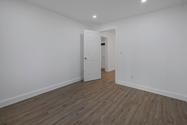 unfurnished room with dark hardwood / wood-style floors