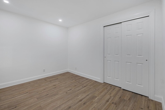 unfurnished bedroom with a closet and light hardwood / wood-style flooring