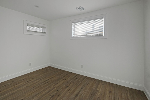 spare room with dark hardwood / wood-style flooring