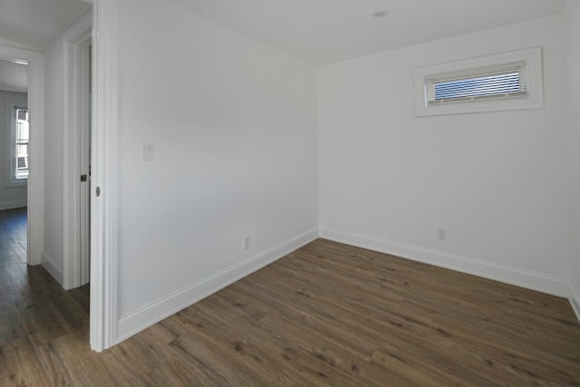 spare room with dark wood-type flooring