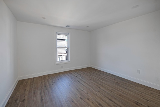 unfurnished room featuring dark hardwood / wood-style flooring