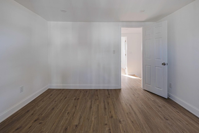 spare room featuring dark wood-type flooring