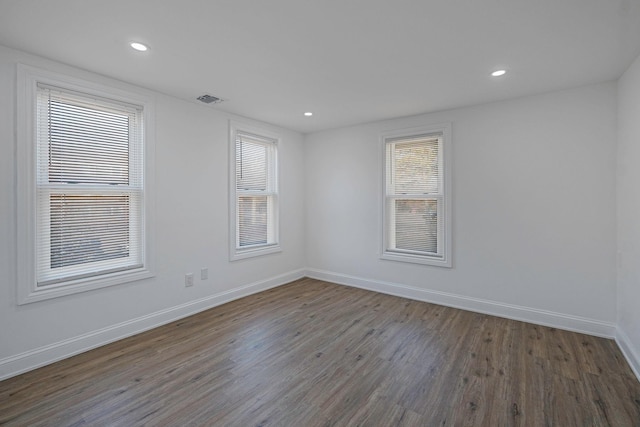 empty room with dark hardwood / wood-style flooring