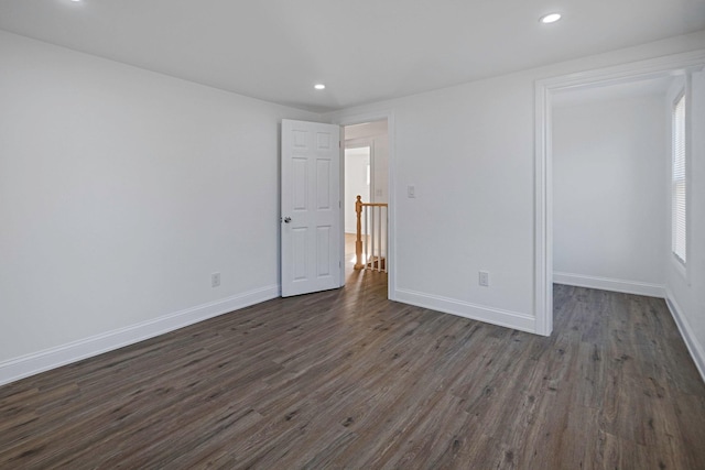 spare room with dark wood-type flooring