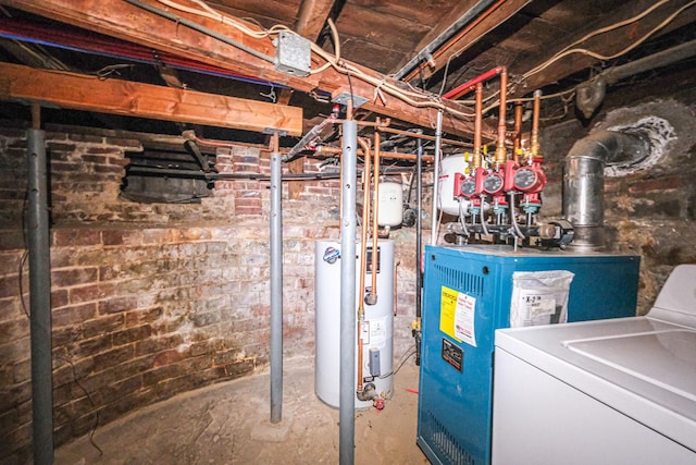 basement with brick wall, washer / dryer, and water heater