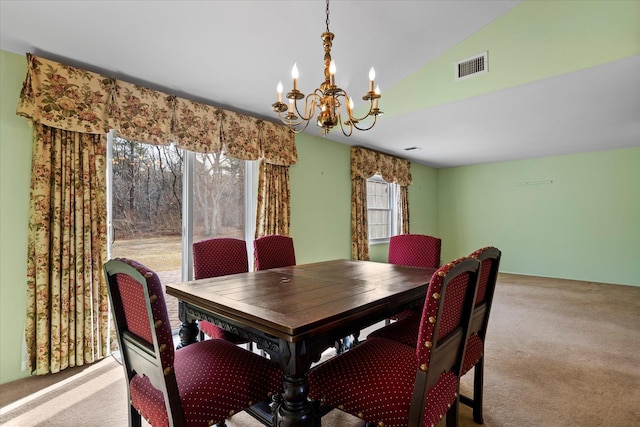 dining space featuring an inviting chandelier, light colored carpet, and lofted ceiling