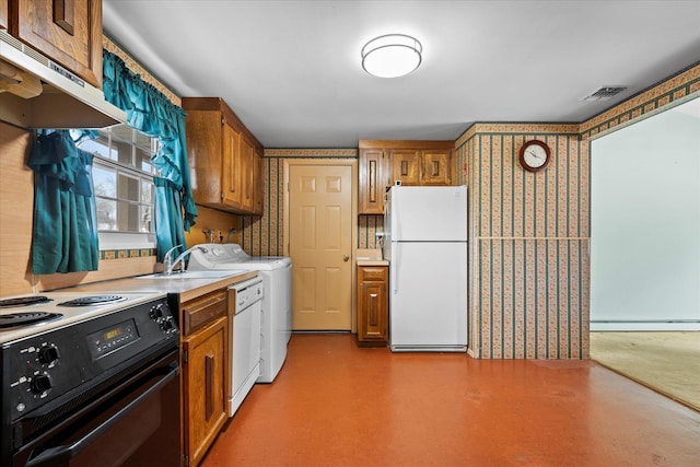 kitchen featuring white appliances, a baseboard radiator, washer and clothes dryer, and sink