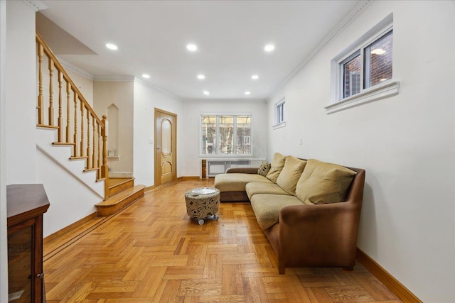 living room featuring ornamental molding, radiator heating unit, and light parquet floors