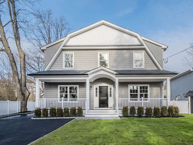 front facade with a porch and a front lawn