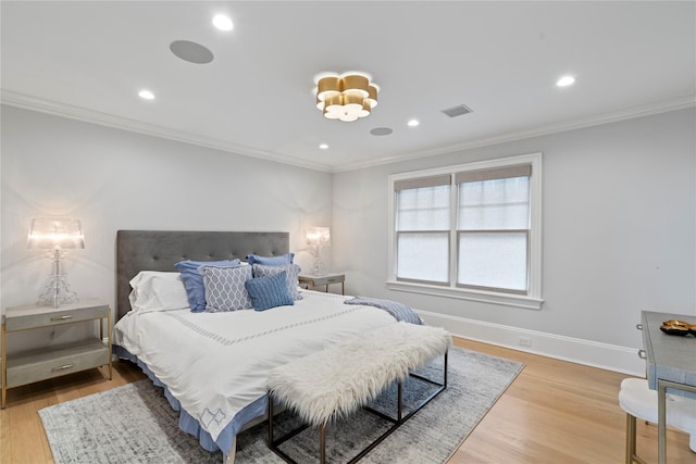 bedroom featuring ornamental molding, light wood-style floors, and baseboards