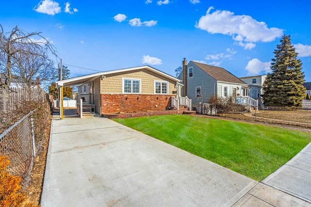 back of house with a carport and a lawn