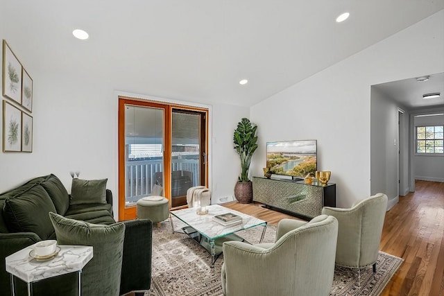 living room featuring hardwood / wood-style flooring and lofted ceiling