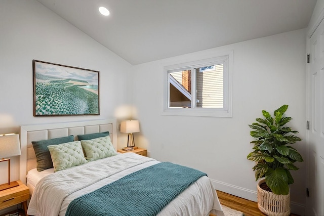 bedroom with hardwood / wood-style floors and vaulted ceiling