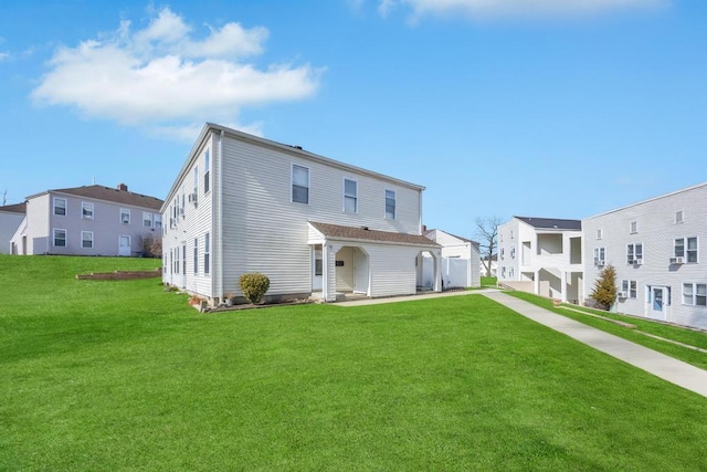 rear view of property featuring a residential view and a yard