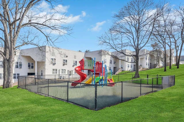 community playground with a yard and fence