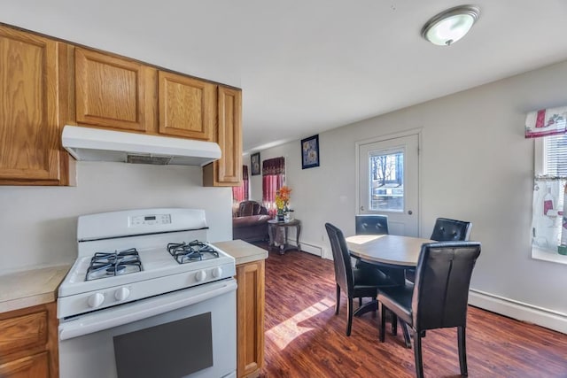 kitchen featuring brown cabinetry, light countertops, white range with gas cooktop, and under cabinet range hood