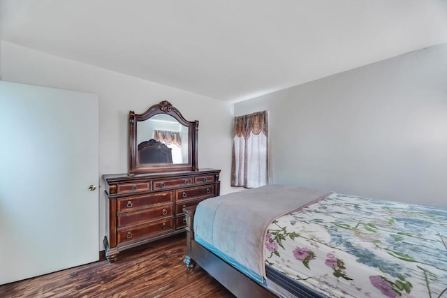 bedroom with dark wood-style floors