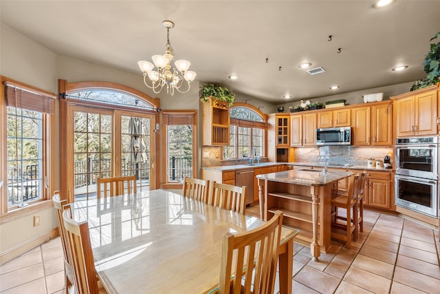 dining room with light tile patterned floors, recessed lighting, a notable chandelier, visible vents, and baseboards