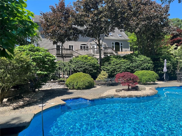 outdoor pool with a wooden deck