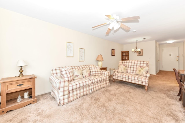 living room with ceiling fan with notable chandelier and carpet floors