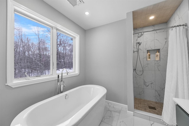 bathroom featuring a wealth of natural light and plus walk in shower