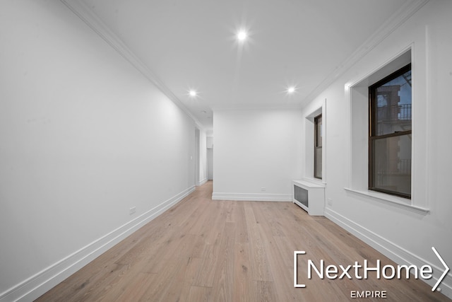 interior space with crown molding and light hardwood / wood-style flooring