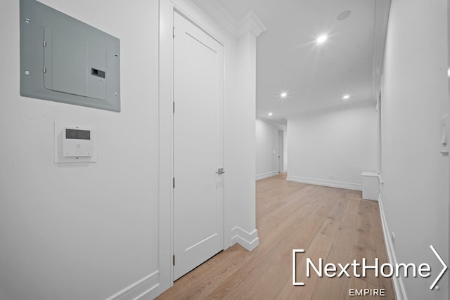 hallway featuring electric panel and light hardwood / wood-style floors