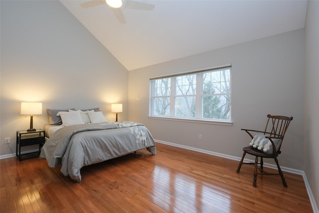 bedroom with ceiling fan, high vaulted ceiling, wood finished floors, and baseboards