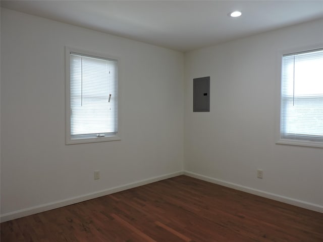 unfurnished room featuring dark wood-type flooring and electric panel