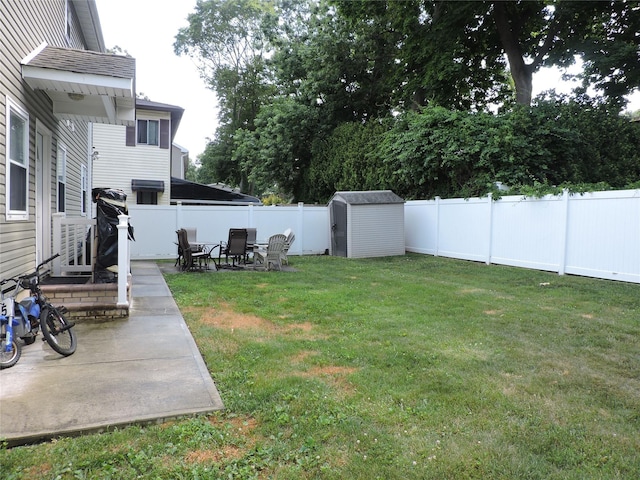 view of yard with a storage unit and a patio area