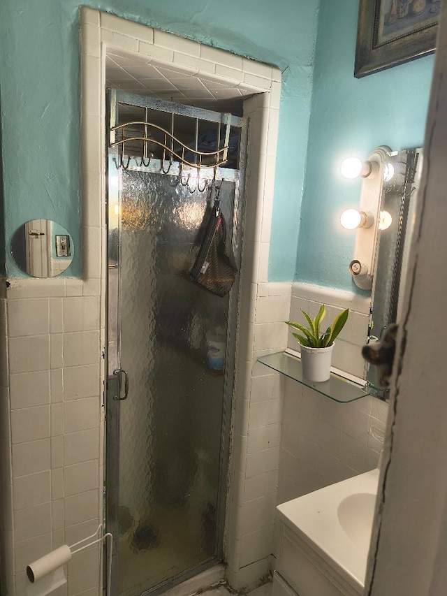 87-08 31st Ave, East Elmhurst, NY 11369 - full bathroom featuring tile walls, a shower stall, vanity, and wainscoting
