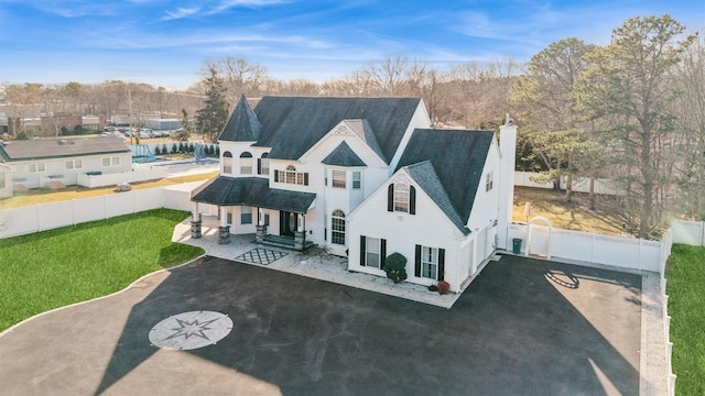 back of house featuring a patio area and a lawn