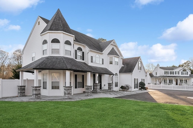 rear view of house with a lawn and a patio