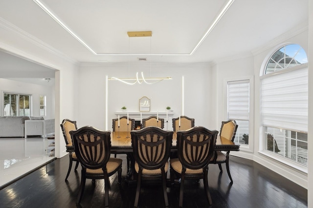 dining area with ornamental molding, a wealth of natural light, and dark hardwood / wood-style flooring