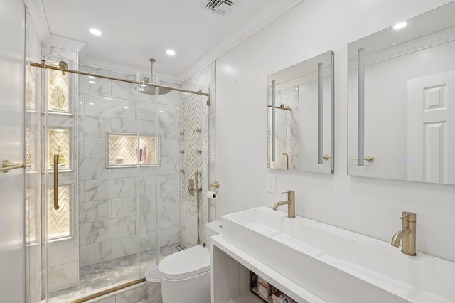 bathroom with crown molding, vanity, toilet, and a shower with shower door