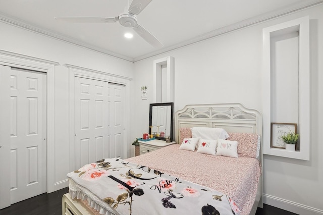 bedroom with dark hardwood / wood-style flooring, crown molding, and ceiling fan