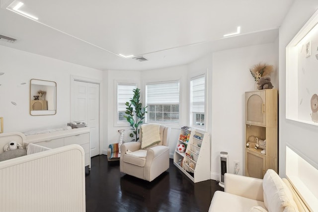 bedroom with dark wood-type flooring and a closet