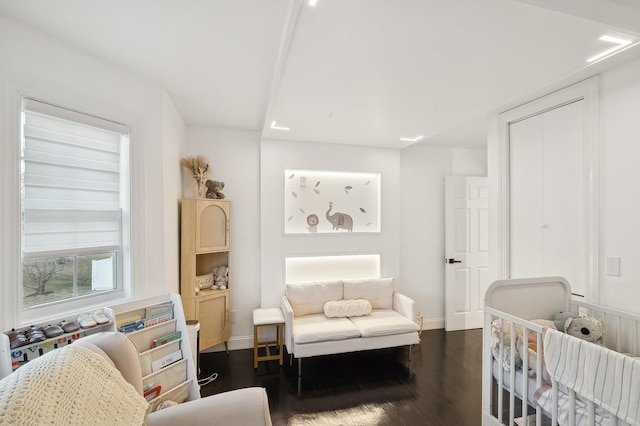 bedroom with dark wood-type flooring and a closet