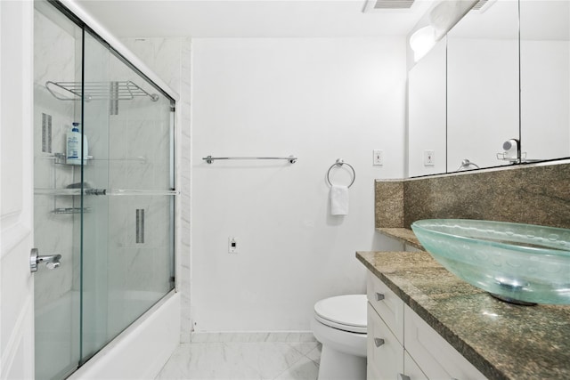 full bathroom with vanity, enclosed tub / shower combo, and toilet