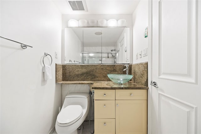 bathroom with vanity, a shower with door, and toilet